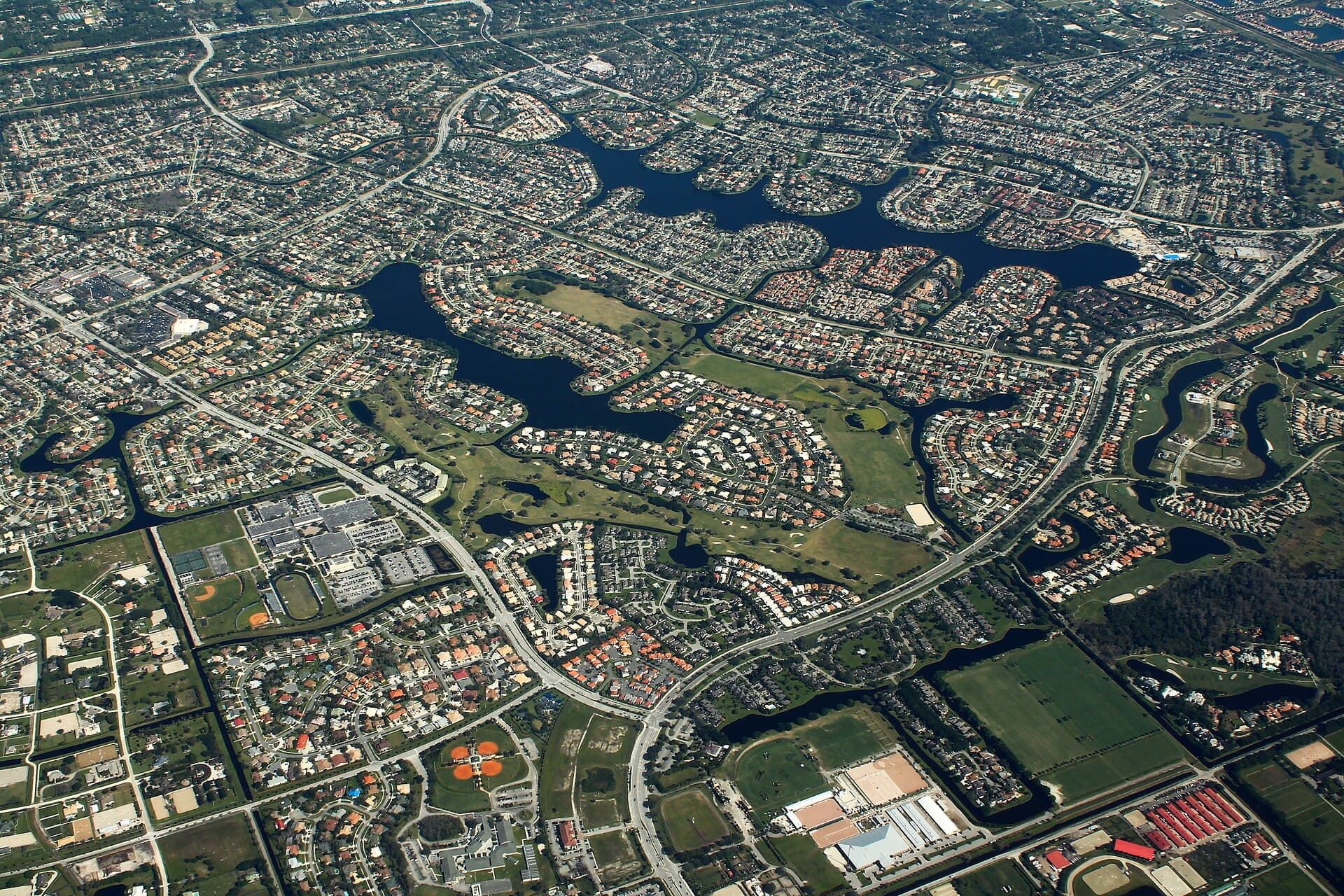 Aerial view of Wellington, Florida: lakes and planned neighborhoods with show arenas and paddocks along the southern edge